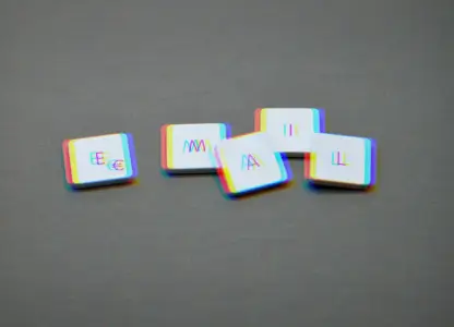 Letter tiles spelling EMAIL on a grey surface