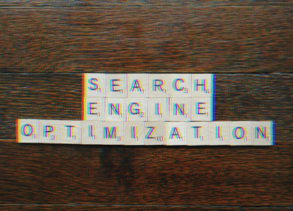Letter tiles spelling out Search Engine Optimization on a wooden table