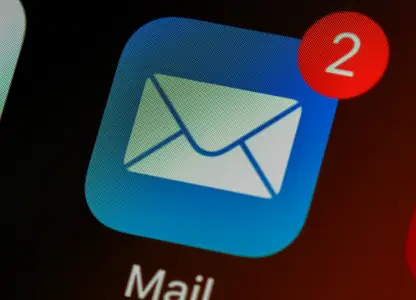 Close-up of a phone screen showing the Mail app icon with two unread emails