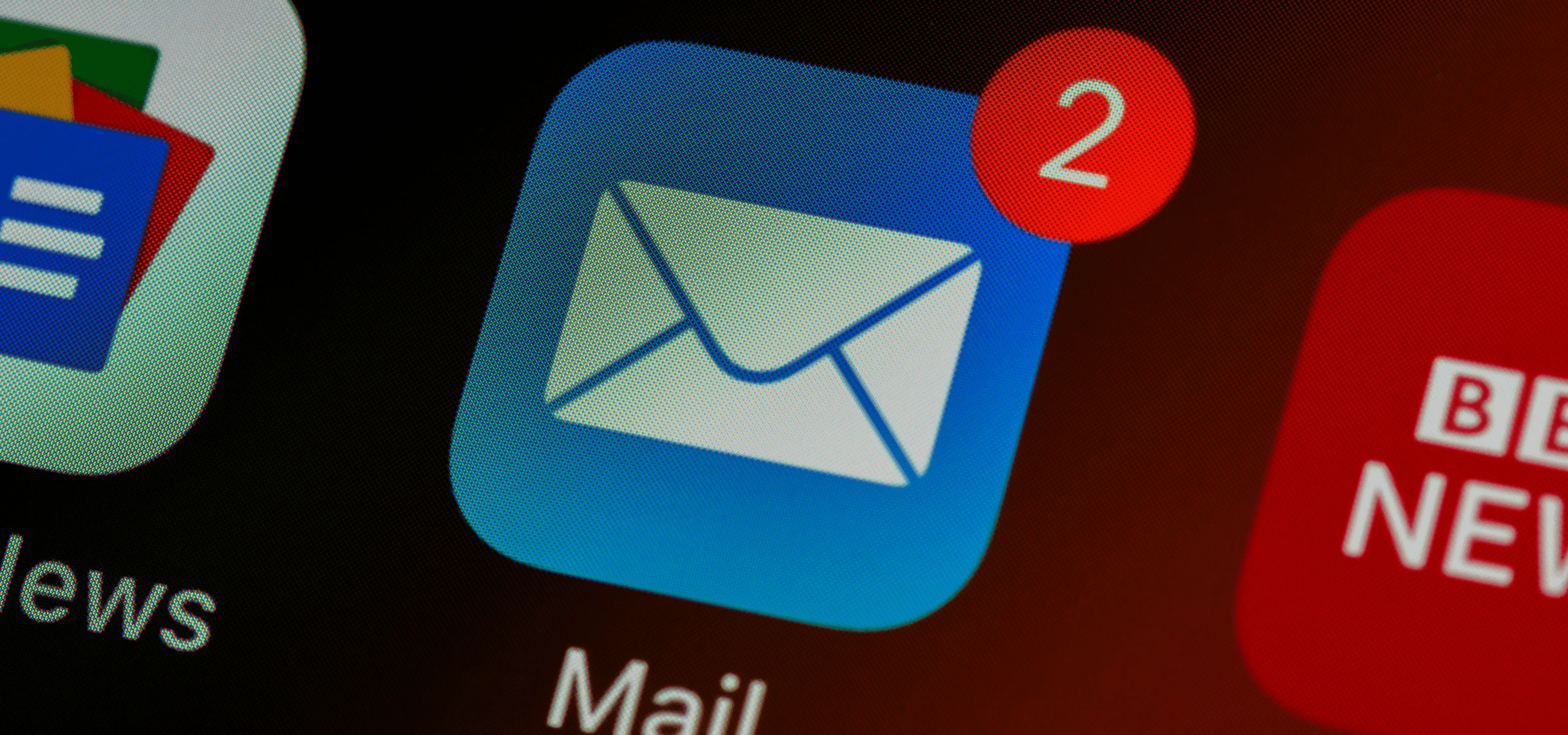 Close-up of a phone screen showing the Mail app icon with two unread emails