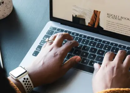 Person typing on a laptop showing an online shop product page