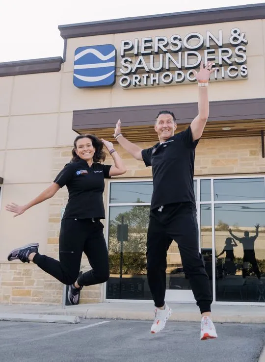 Dr. Pierson and Dr. Saunders jumping in front of the North Loop office.