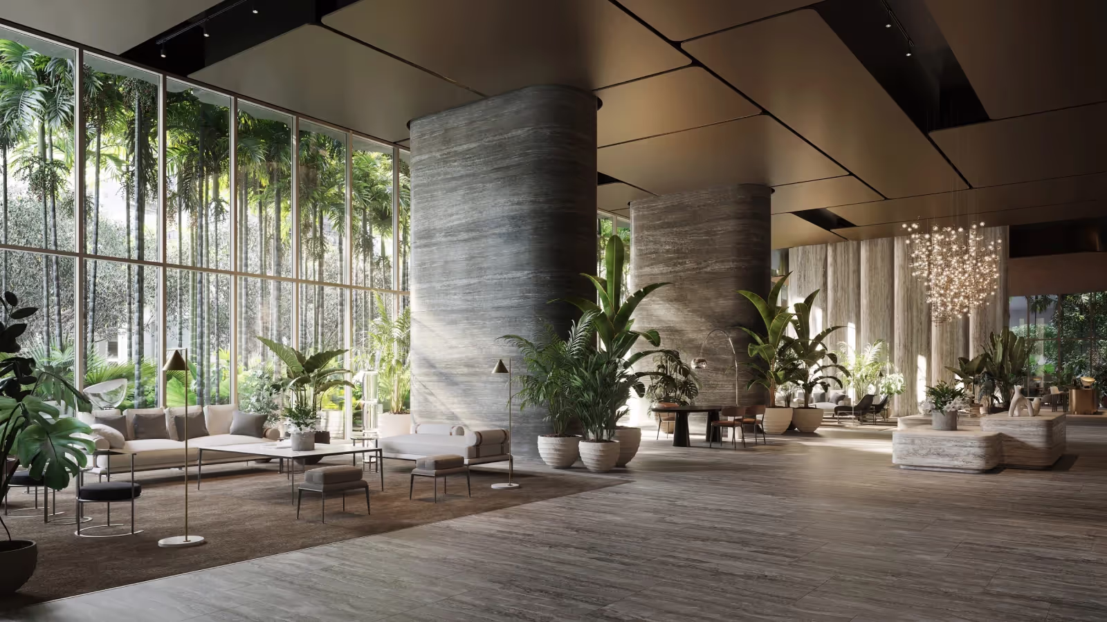 Spacious modern lobby with large circular columns, floor-to-ceiling windows showing tall palm trees outside, and contemporary seating surrounded by lush indoor plants.