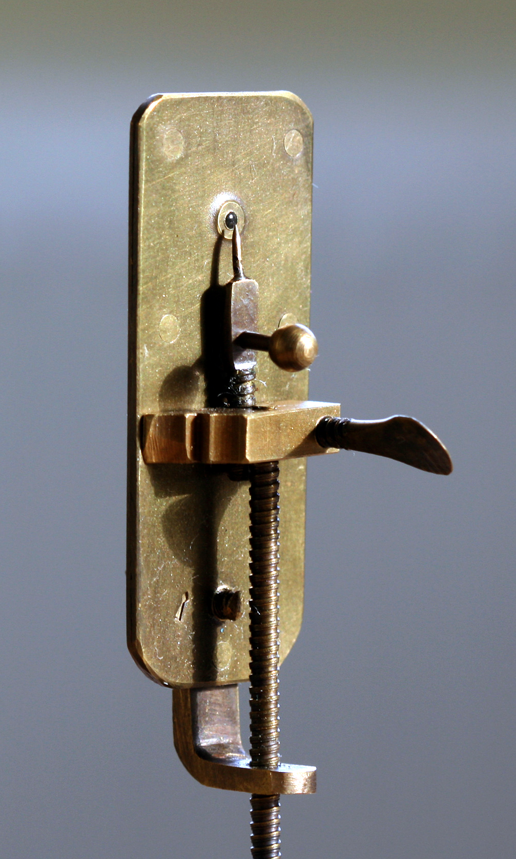 Nachbau eines Leeuwenhoek-Mikroskops: eine winzige Linse zwischen zwei Metallplatten mit Stellschrauben.