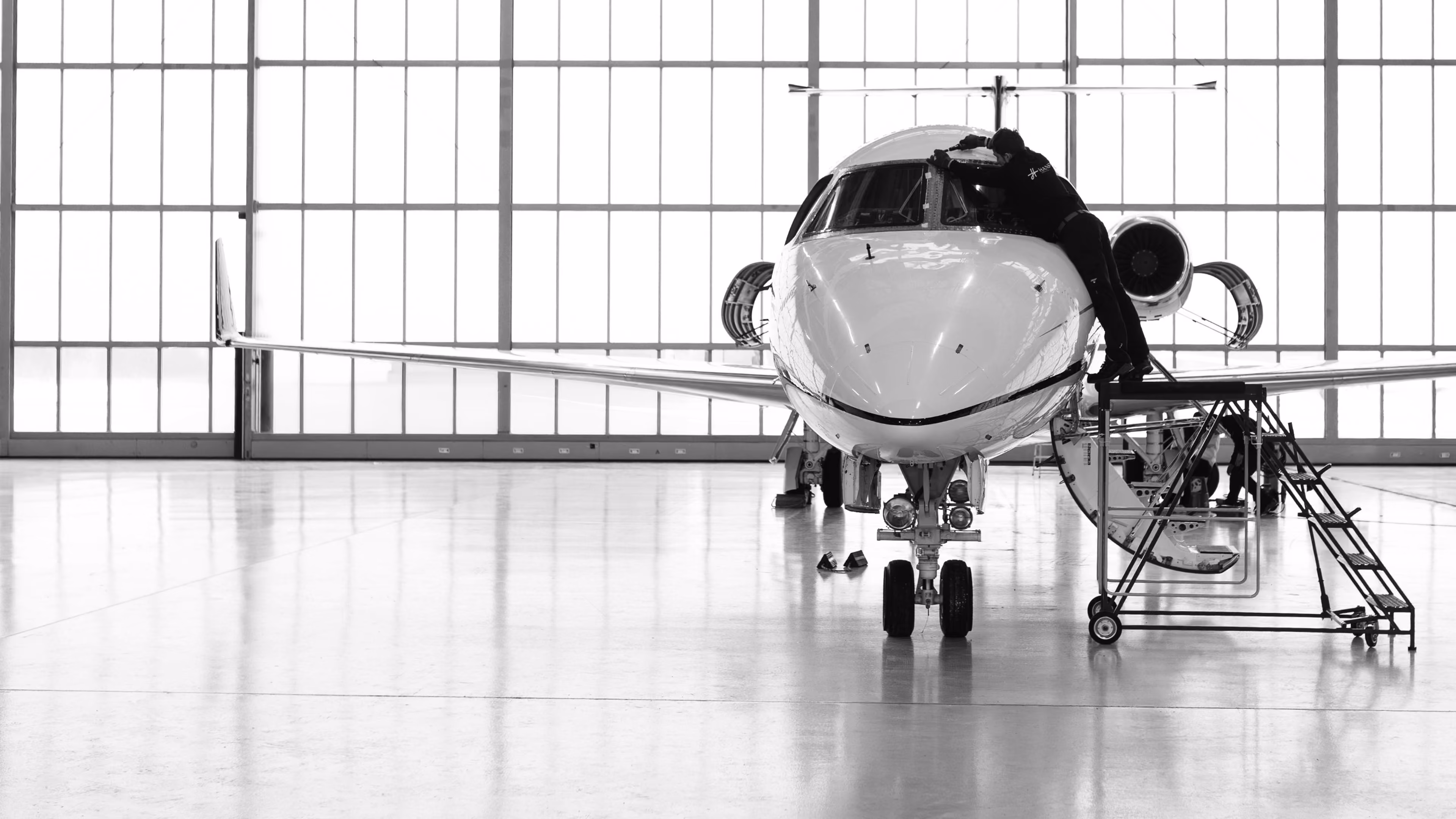 Photo of Hansa Executive MRO maintenance hangar showing business jet maintenance work ongoing process.