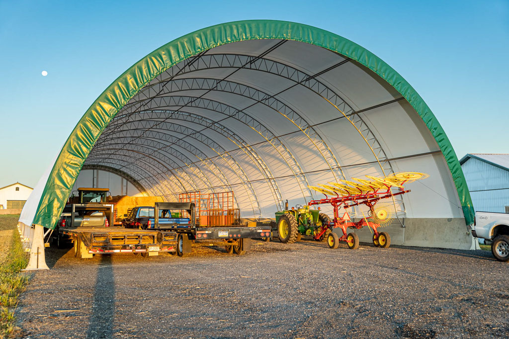 Green and white Thundura fabric structure used for equipment storage