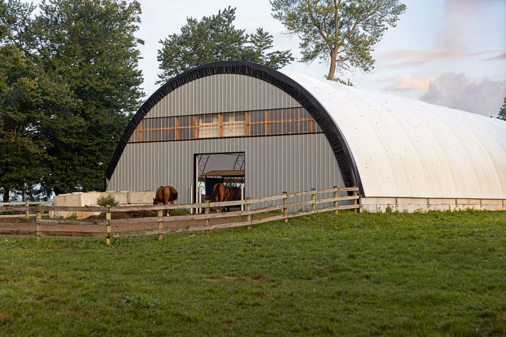 outside view of a thundura fabric building being used for horses