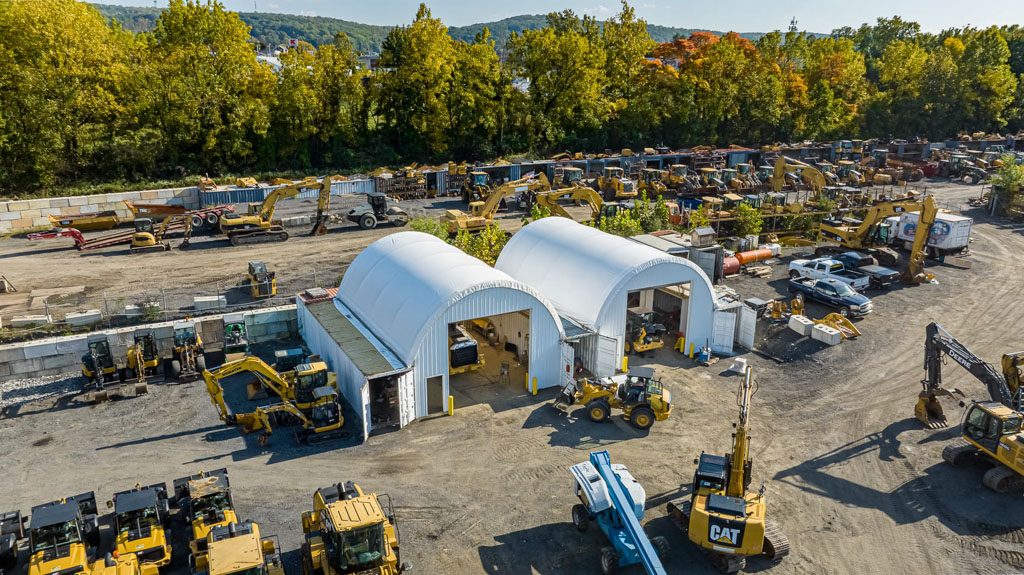 Thundura hoop buildings built on top of shipping containers for equipment storage.