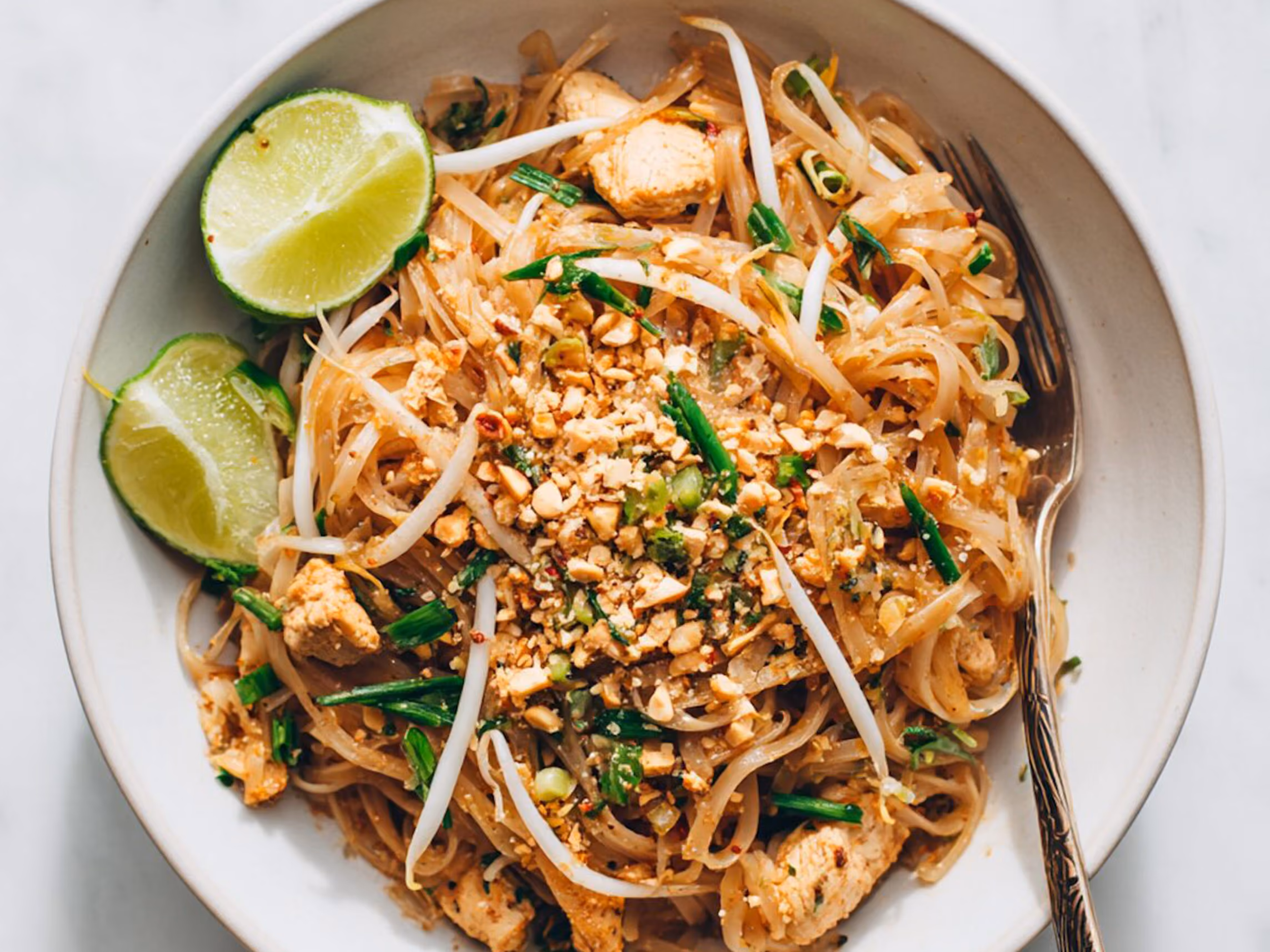 Chicken pad thai with bean sprouts, scallions and peanuts