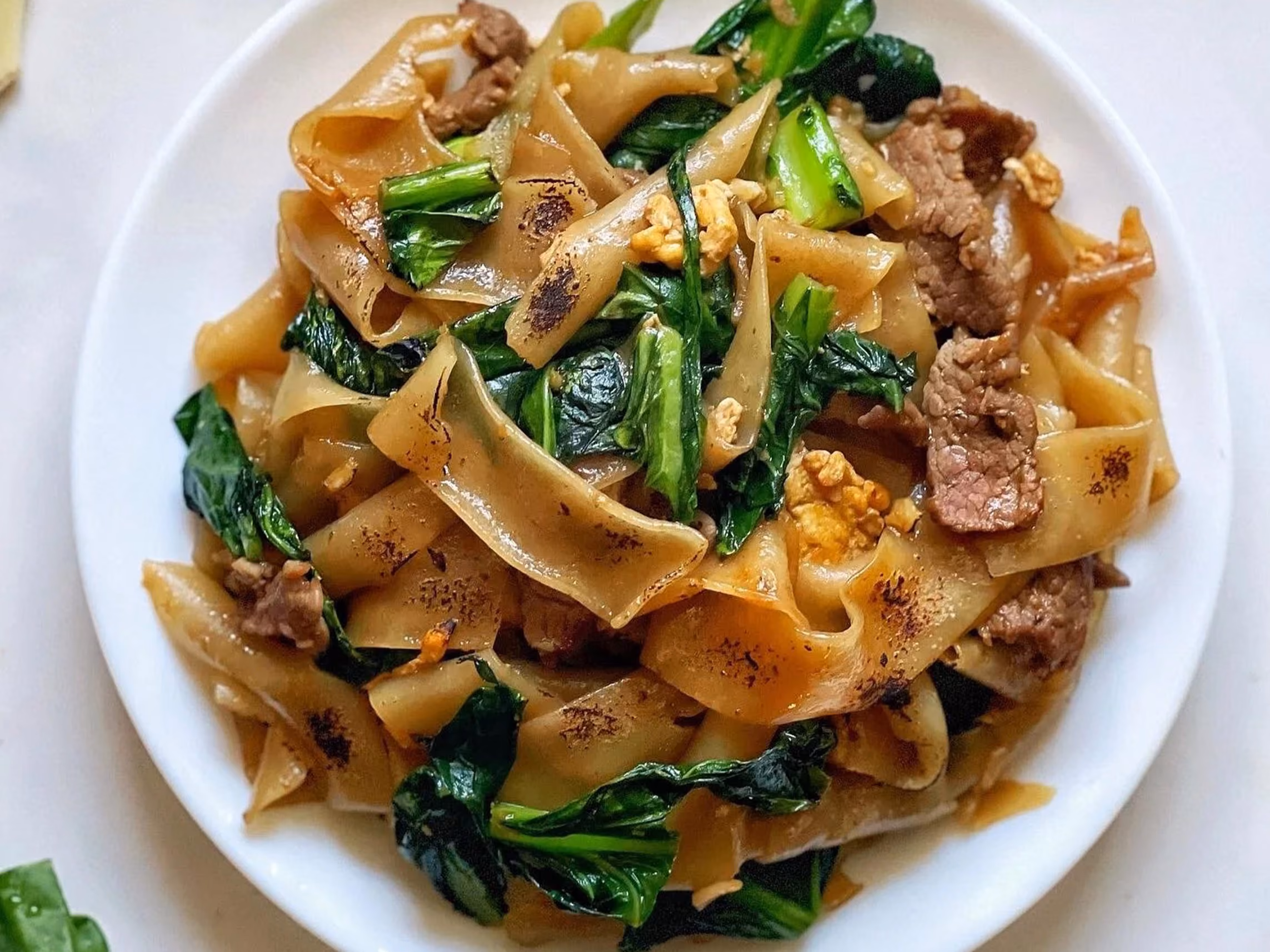 Pad see ew, wide rice noodles with egg, broccoli and sweet soy sauce
