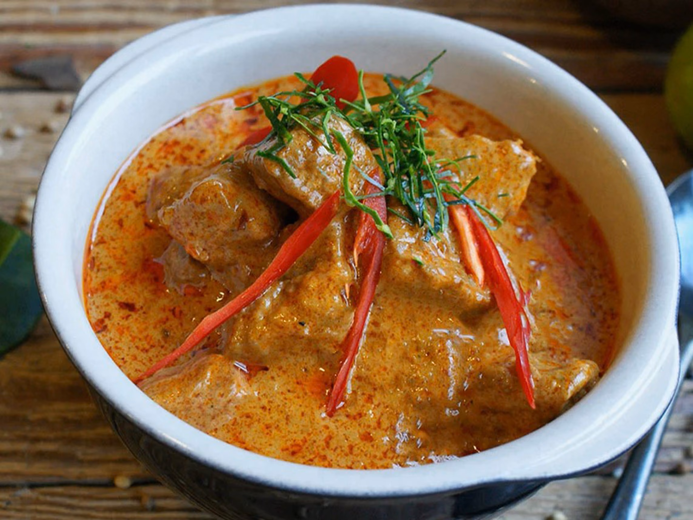 Rich and creamy panang curry with coconut milk, kaffir lime leaves and bell peppers.