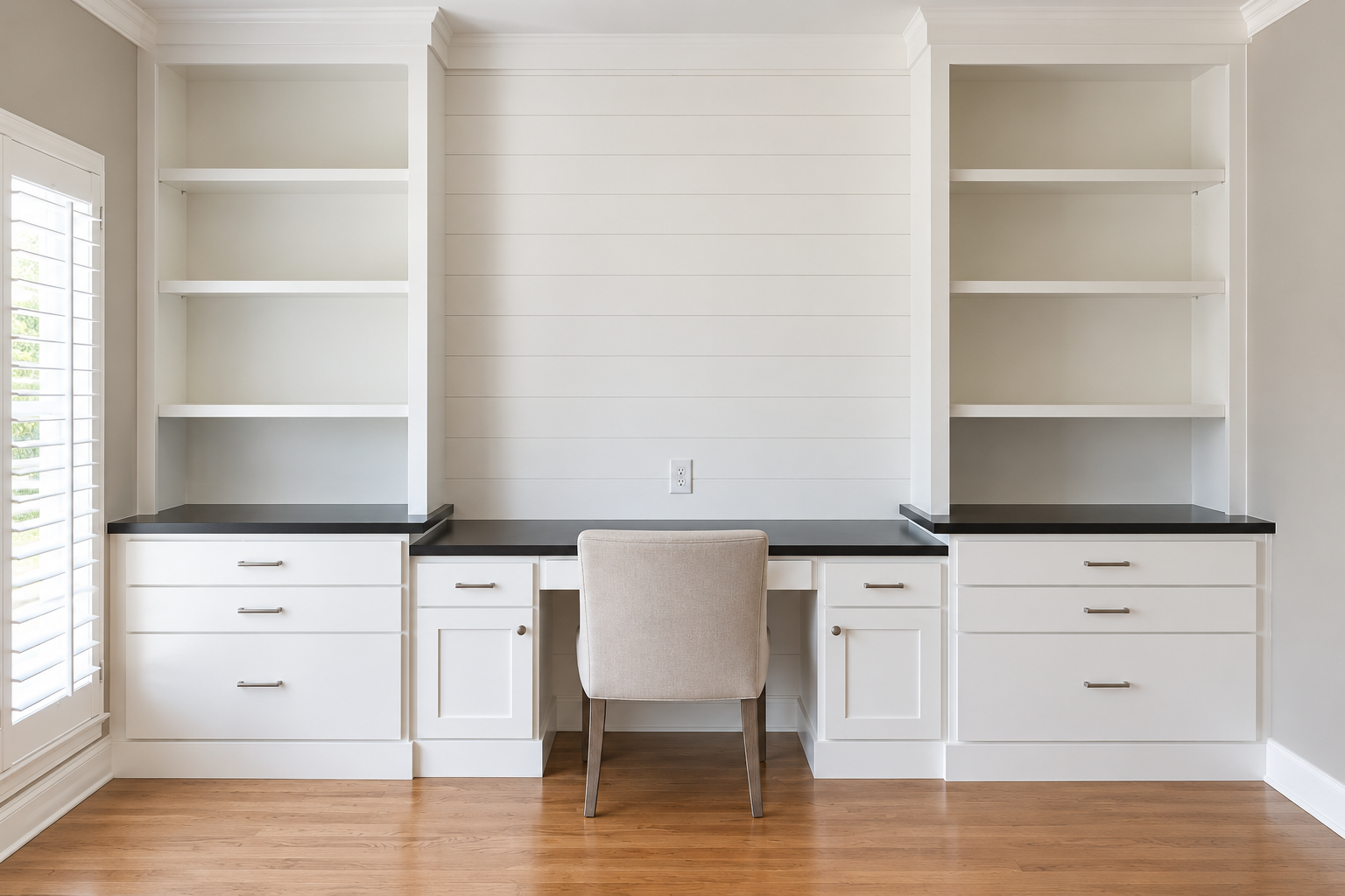 White built-in home office with open bookshelves, drawer banks and a knee-space desk