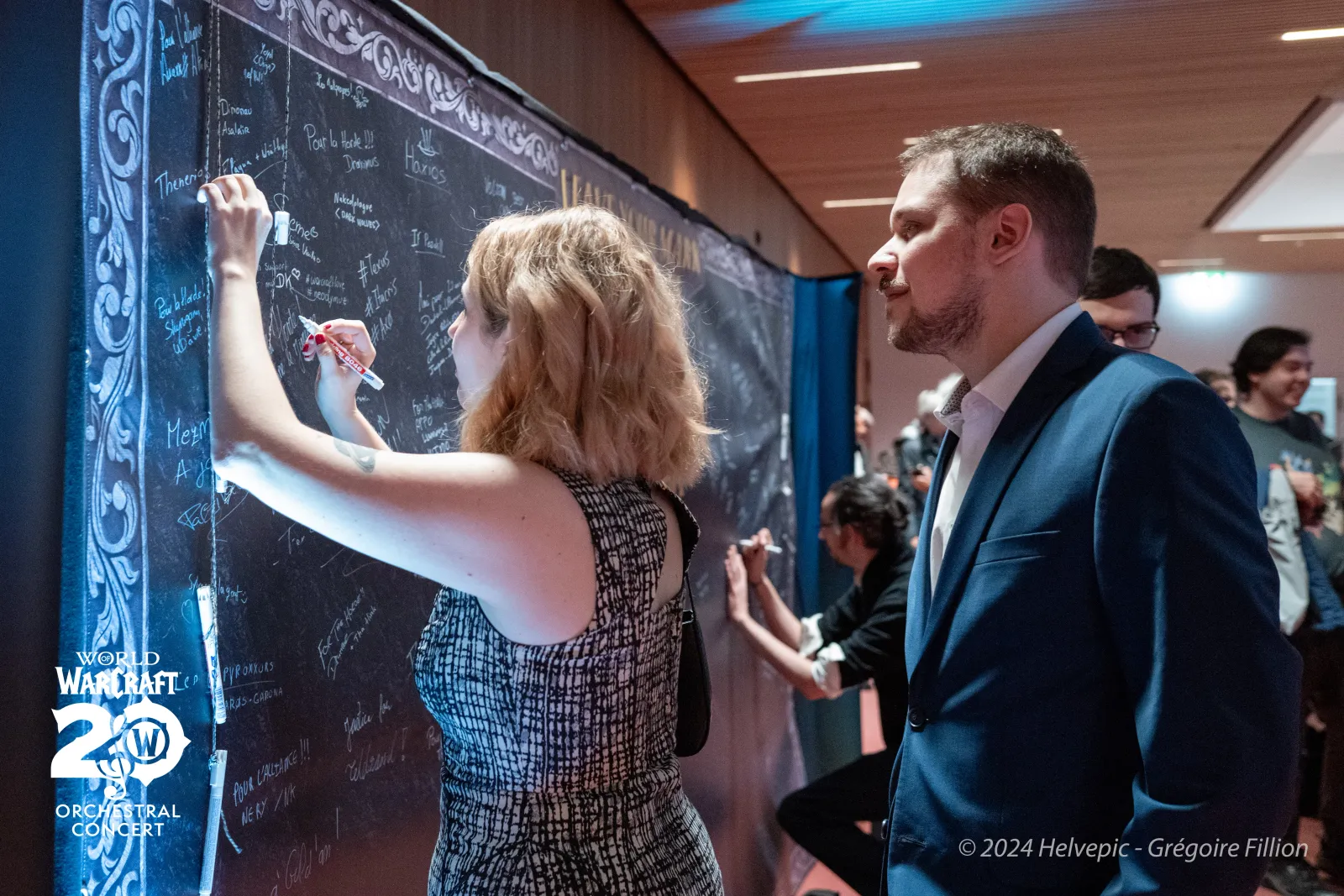 Audience signing the memory wall after the concert
