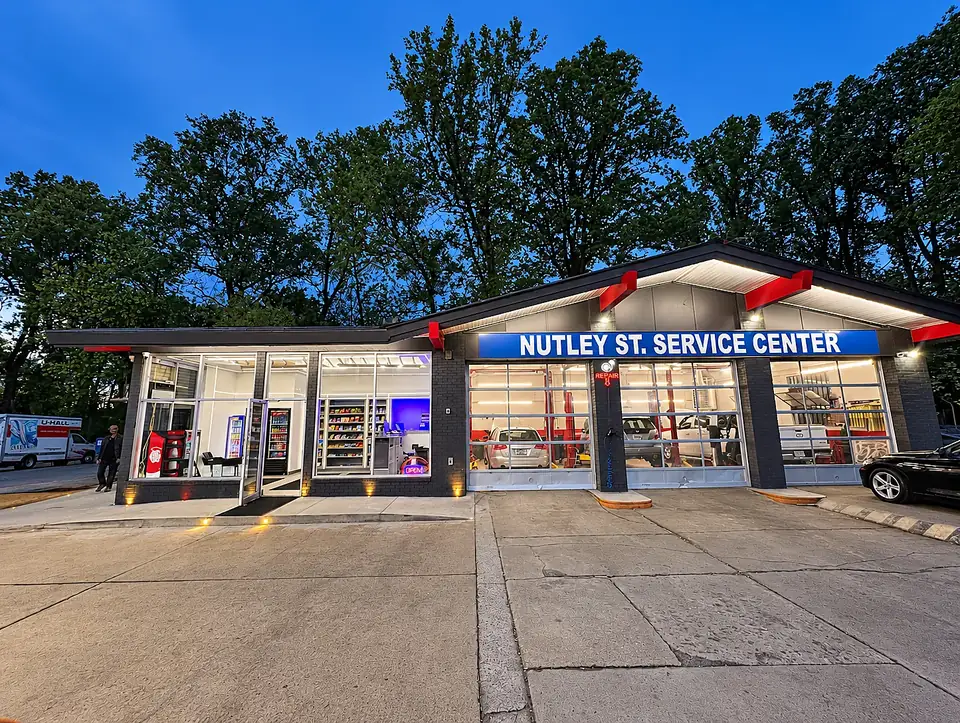 Nutley Street Service Center storefront and illuminated service bays in Fairfax, Virginia