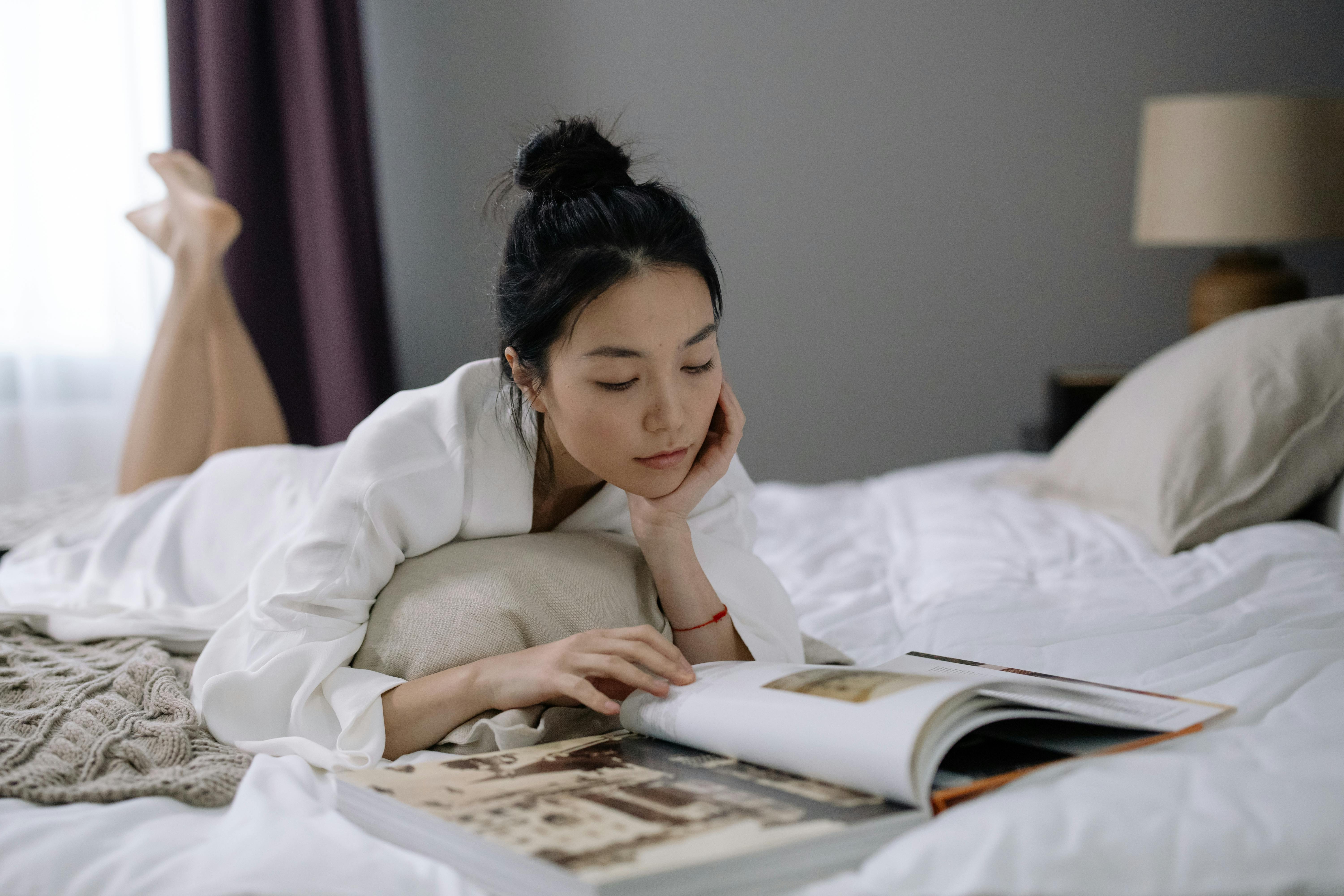 Woman reading on bed stock image