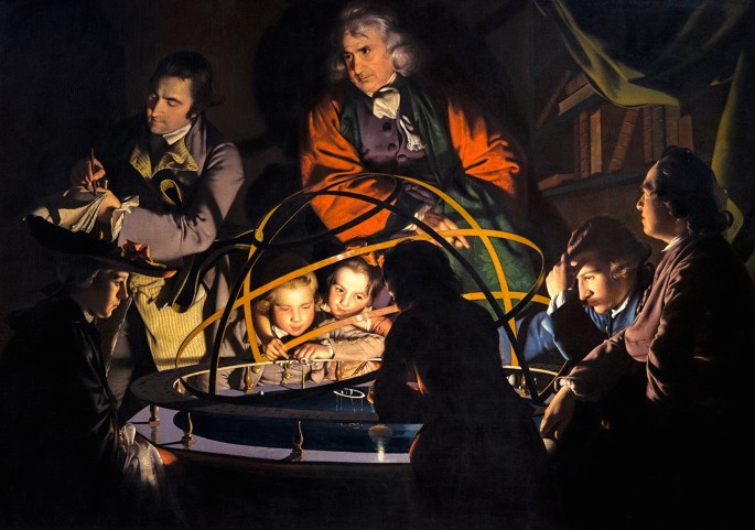 A group gathered around an illuminated orrery in a science demonstration