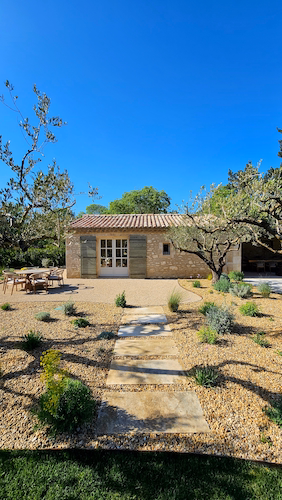Stone villa surrounded by trees and Mediterranean gardens