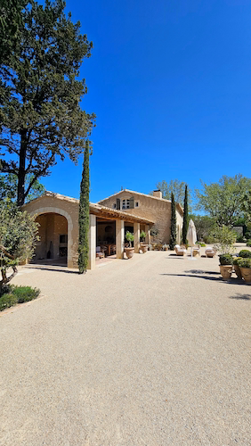 Mediterranean villa surrounded by trees and landscaped grounds