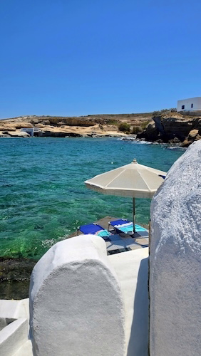 Secluded Mediterranean cove with turquoise water and a seaside terrace