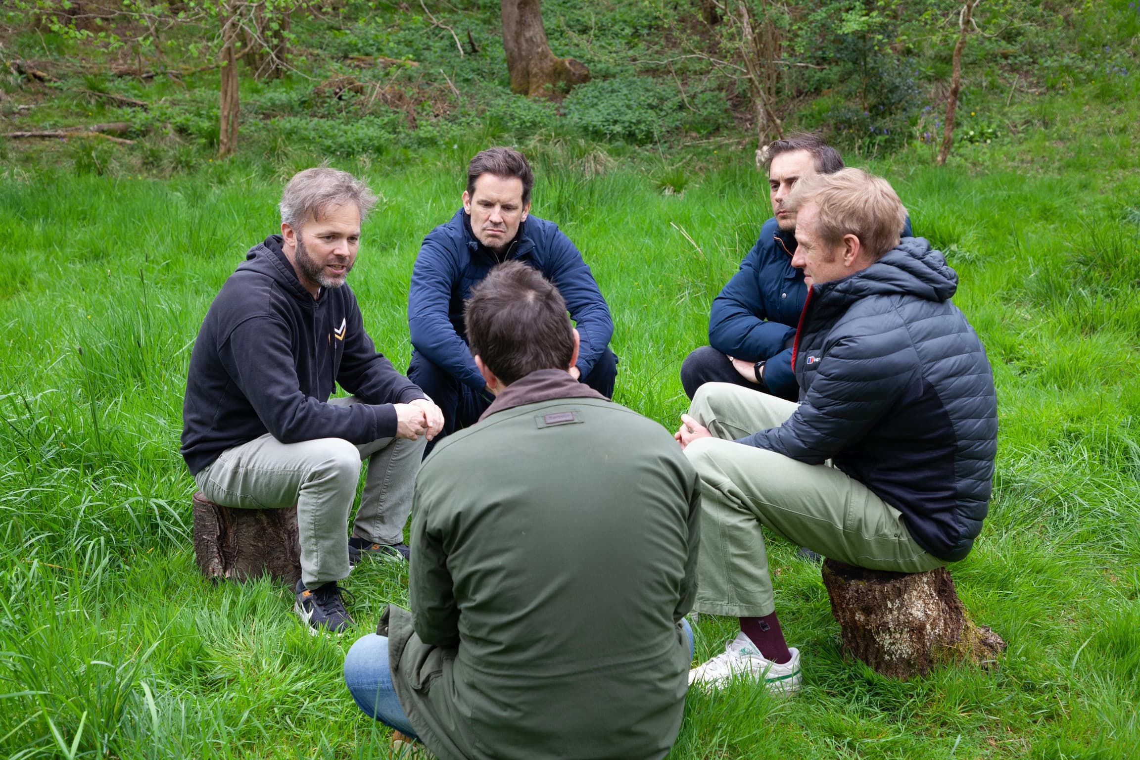 Monumental members gathered in a circle at a UK retreat session