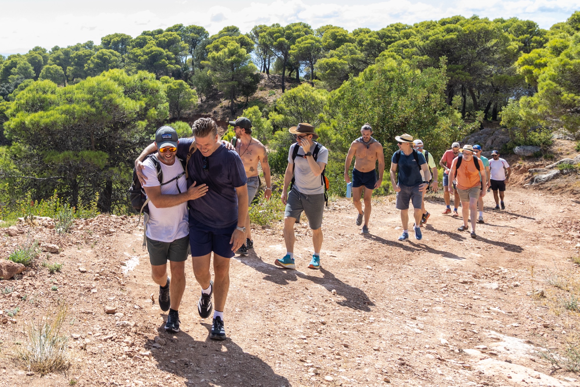 Monumental members walking a mountain trail together in Spain