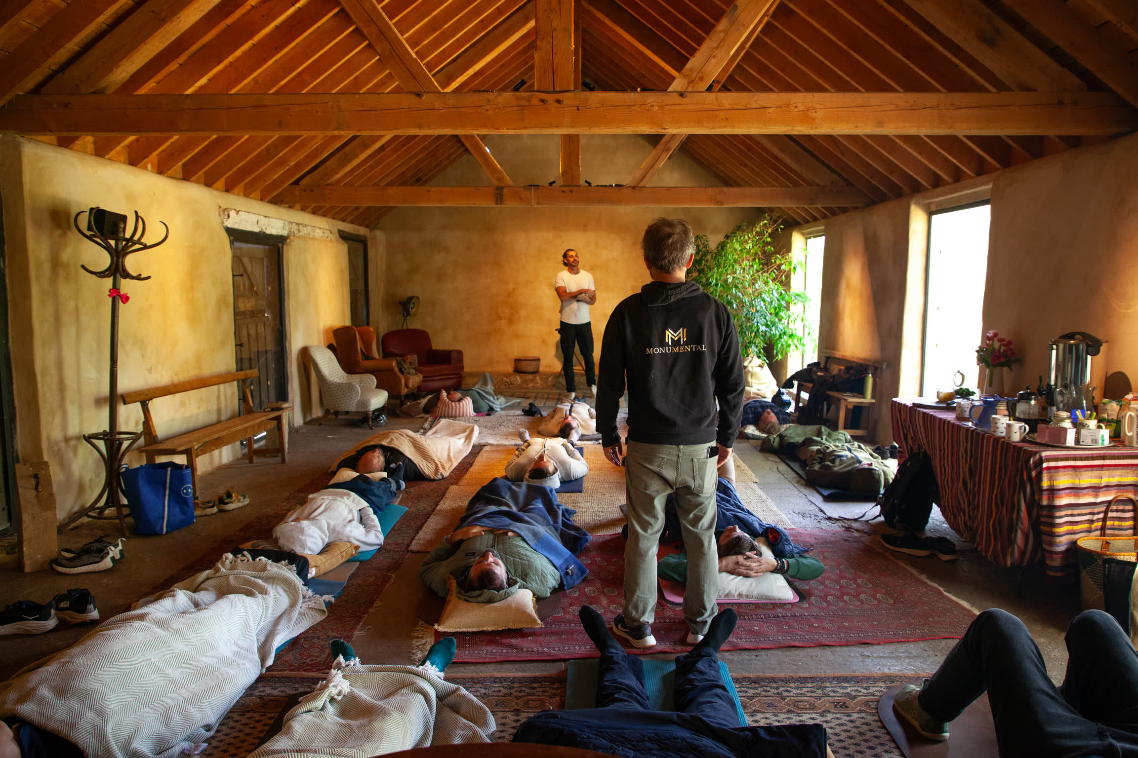 Monumental members resting during a breathwork session at a Monksmead retreat