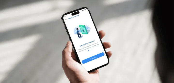 A person holding a cell phone in their hand.