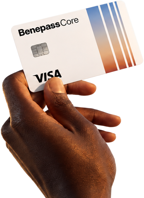 Hand holding up a Benepass Core Visa card in warm sunlight