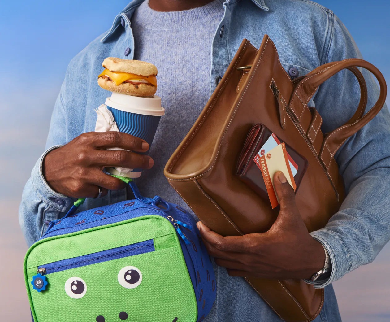 Person carrying a lunch bag, a coffee and a tote