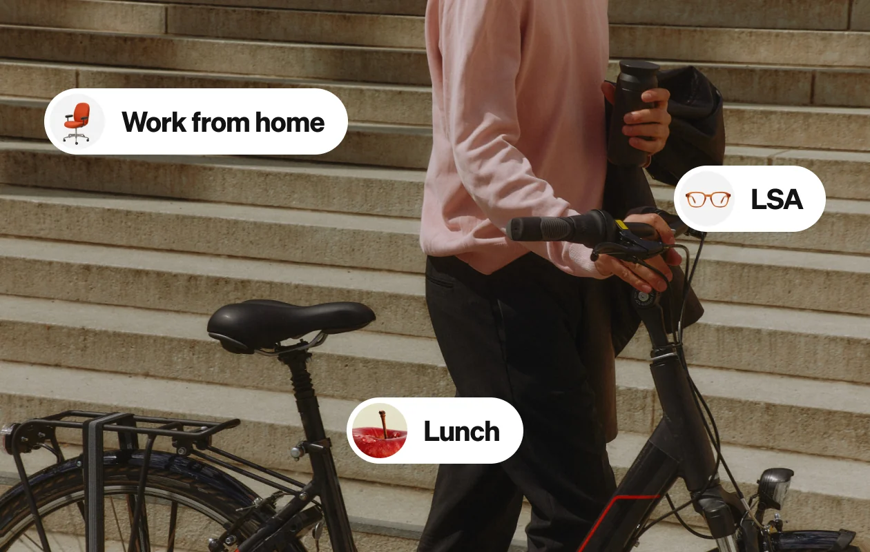 Person walking a bike up steps, with Work from home, LSA and Lunch benefit tags