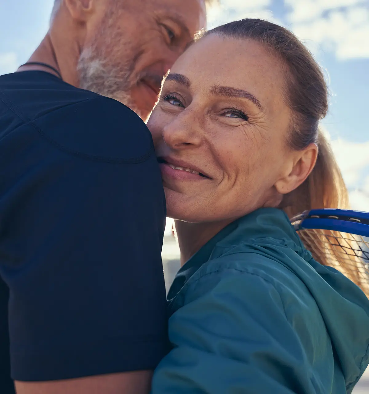 Middle age couple hugging outside