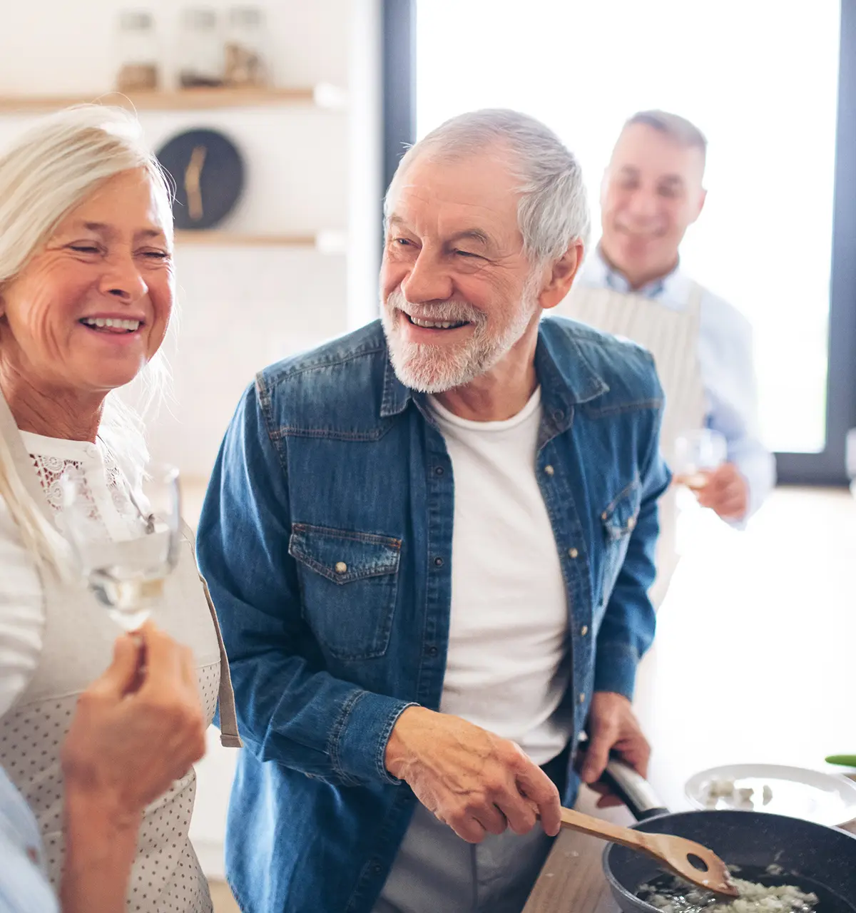 Elderly couple cooking together in kitchen