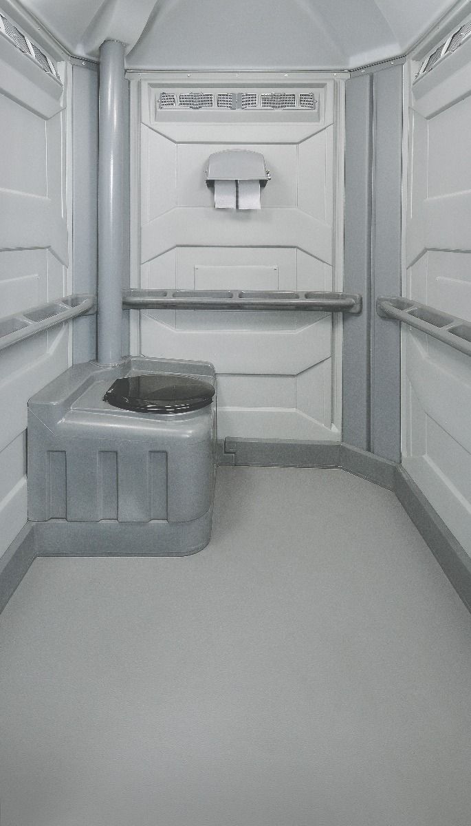 Inside the Large unit: open floor space, seat, grab bars and paper dispenser