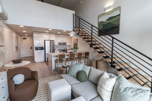Living room looking into kitchen with stairs