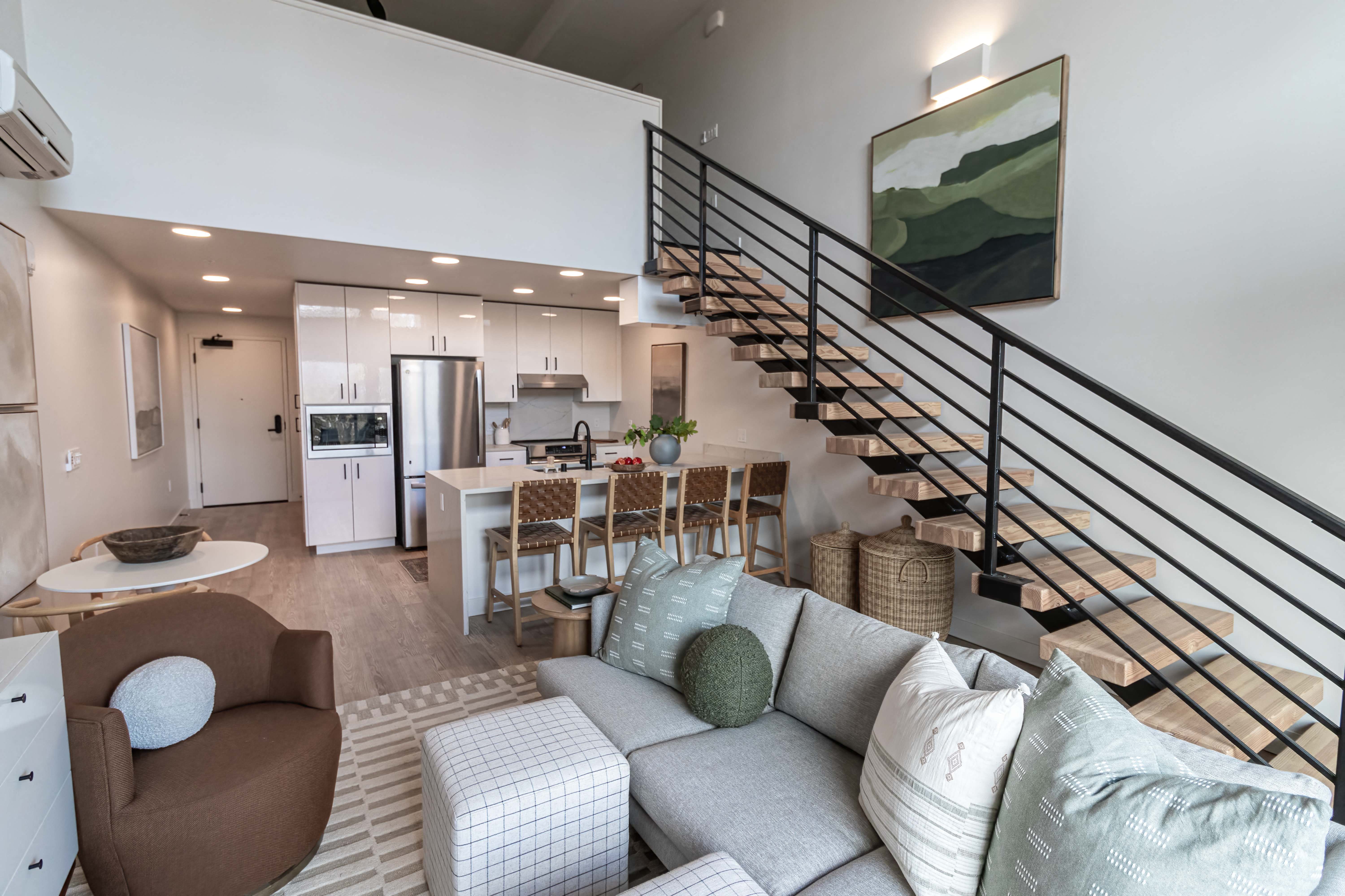 Studio living room with stairs leading up