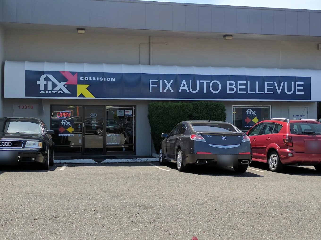 The Fix Auto Bellevue storefront — signed awning over the entrance, cars parked out front