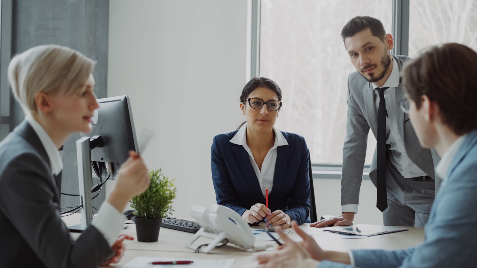 Executives collaborating in a modern office meeting