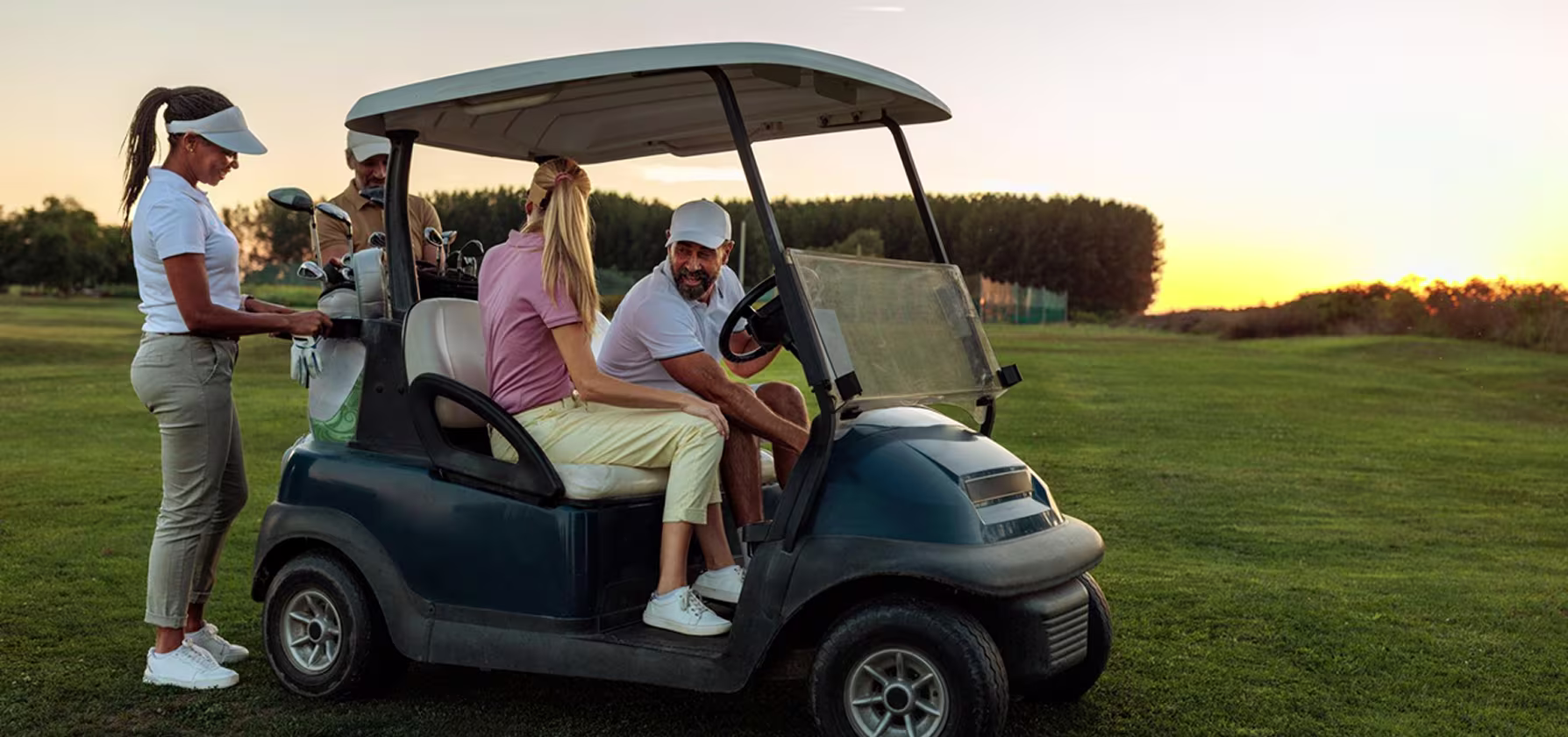 Junior golfer practicing their swing on the driving range with a parent watching nearby