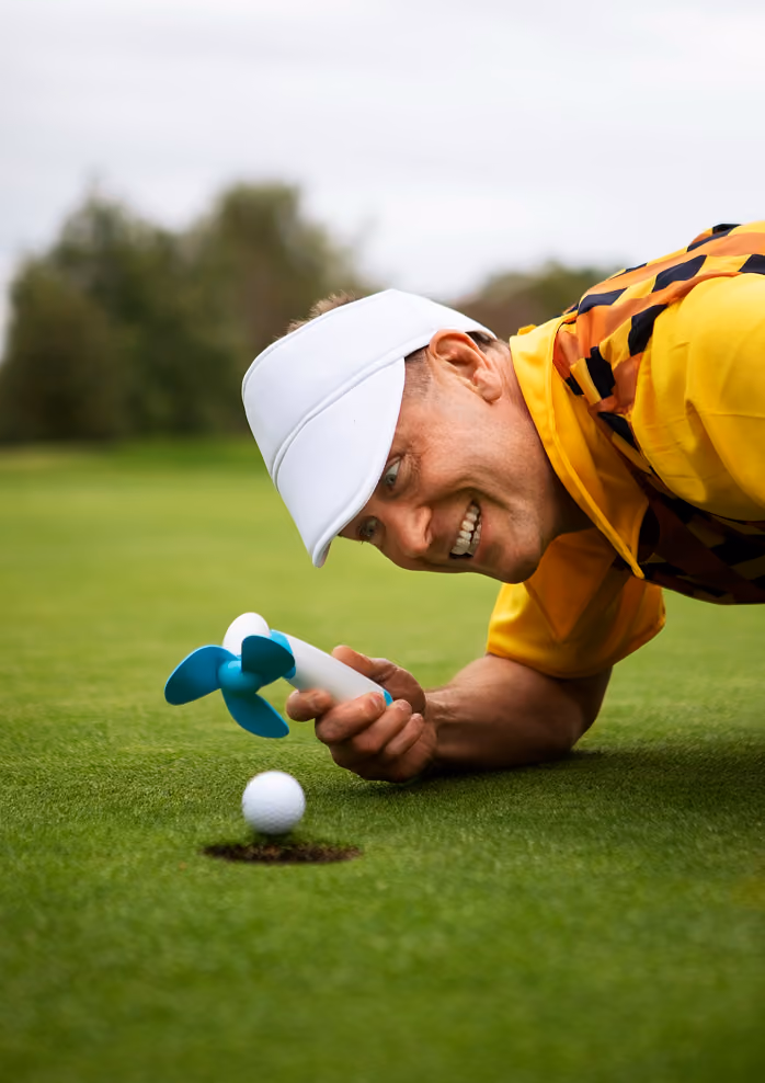 Golfer marking ball on the green