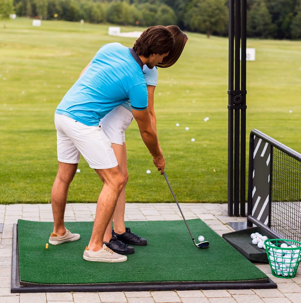 Golfer practicing swing at driving range
