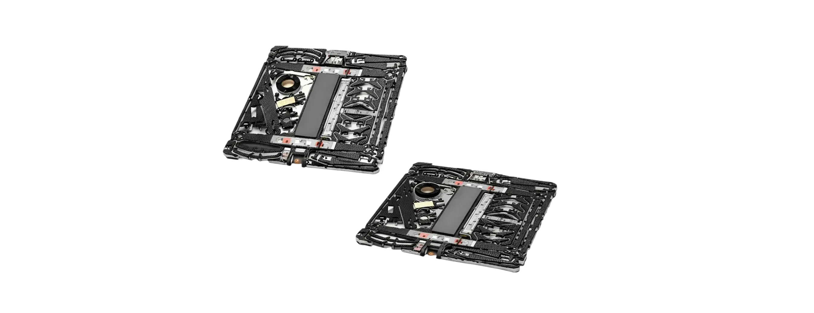 Two black mechanical devices with complex structures and components on a black background.
