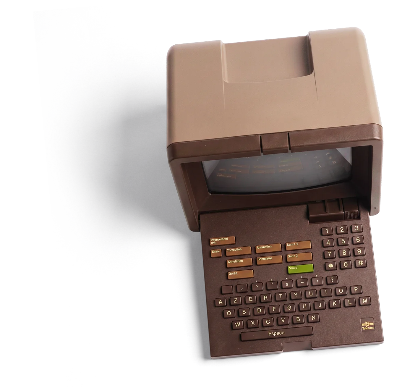 Minitel vintage terminal with a brown plastic casing, small screen at the top, and an AZERTY keyboard with additional labeled buttons in French for navigation and functions.