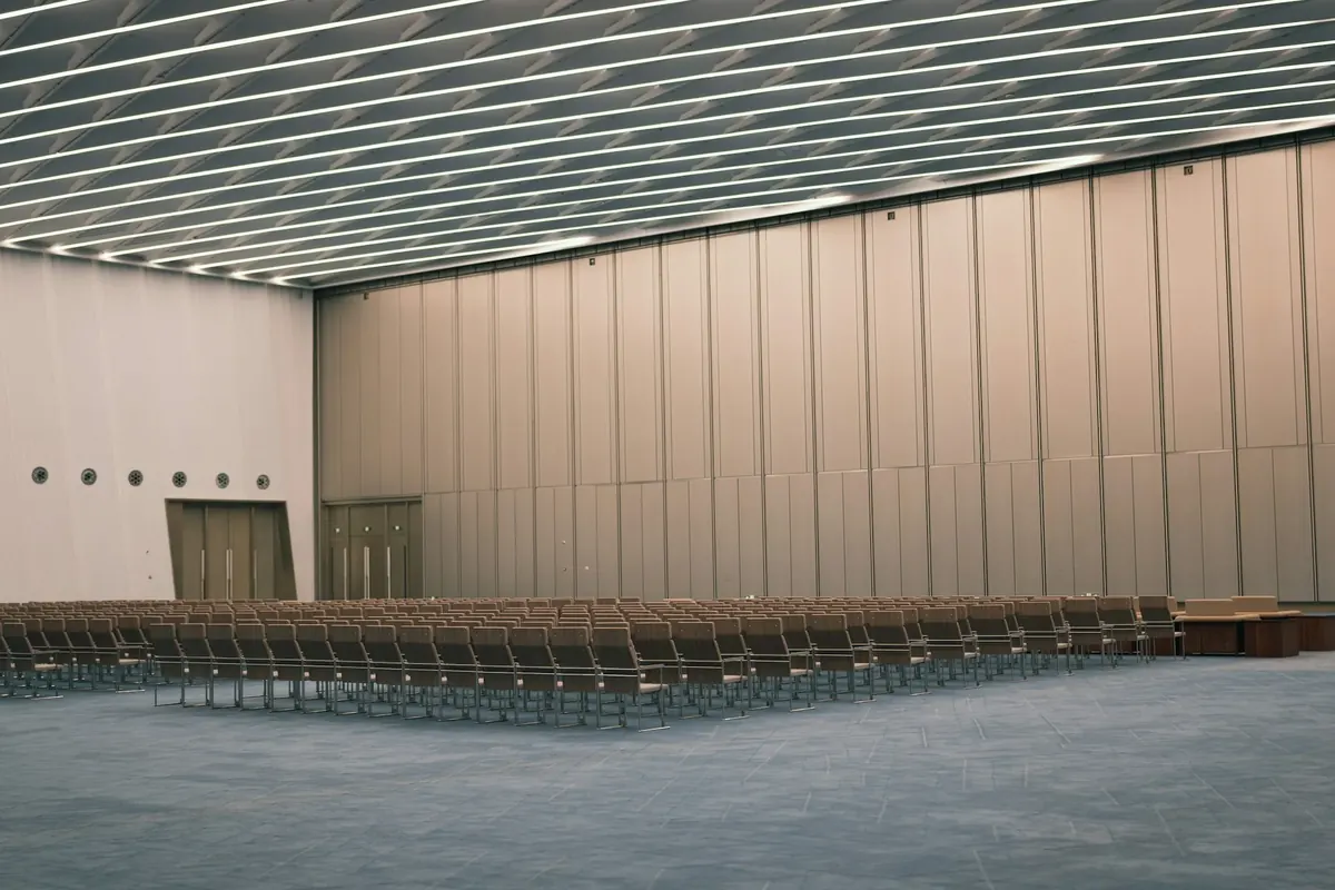 Rows of empty chairs in a large conference hall