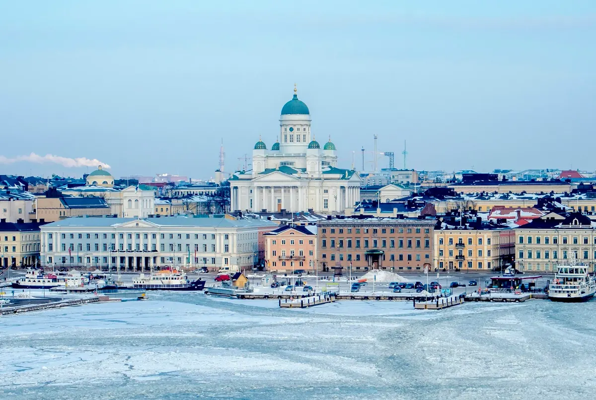 Helsinki Cathedral and the city skyline above the frozen harbour in winter