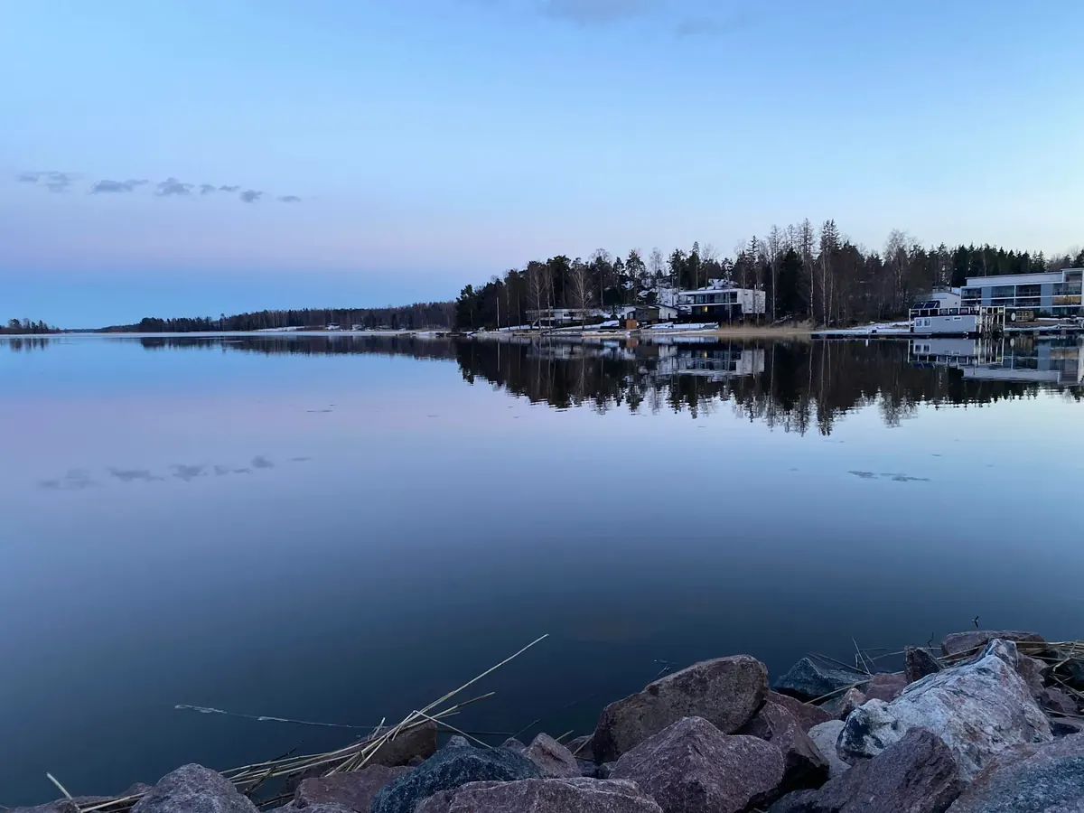 Calm sea and wooded shoreline in Espoo, Finland