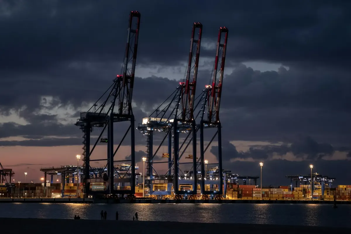 Container cranes at a Baltic Sea port in Gdańsk at dusk