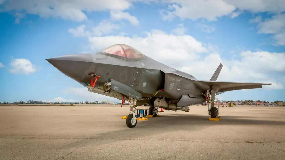 An F-35 fighter jet parked on an airfield apron