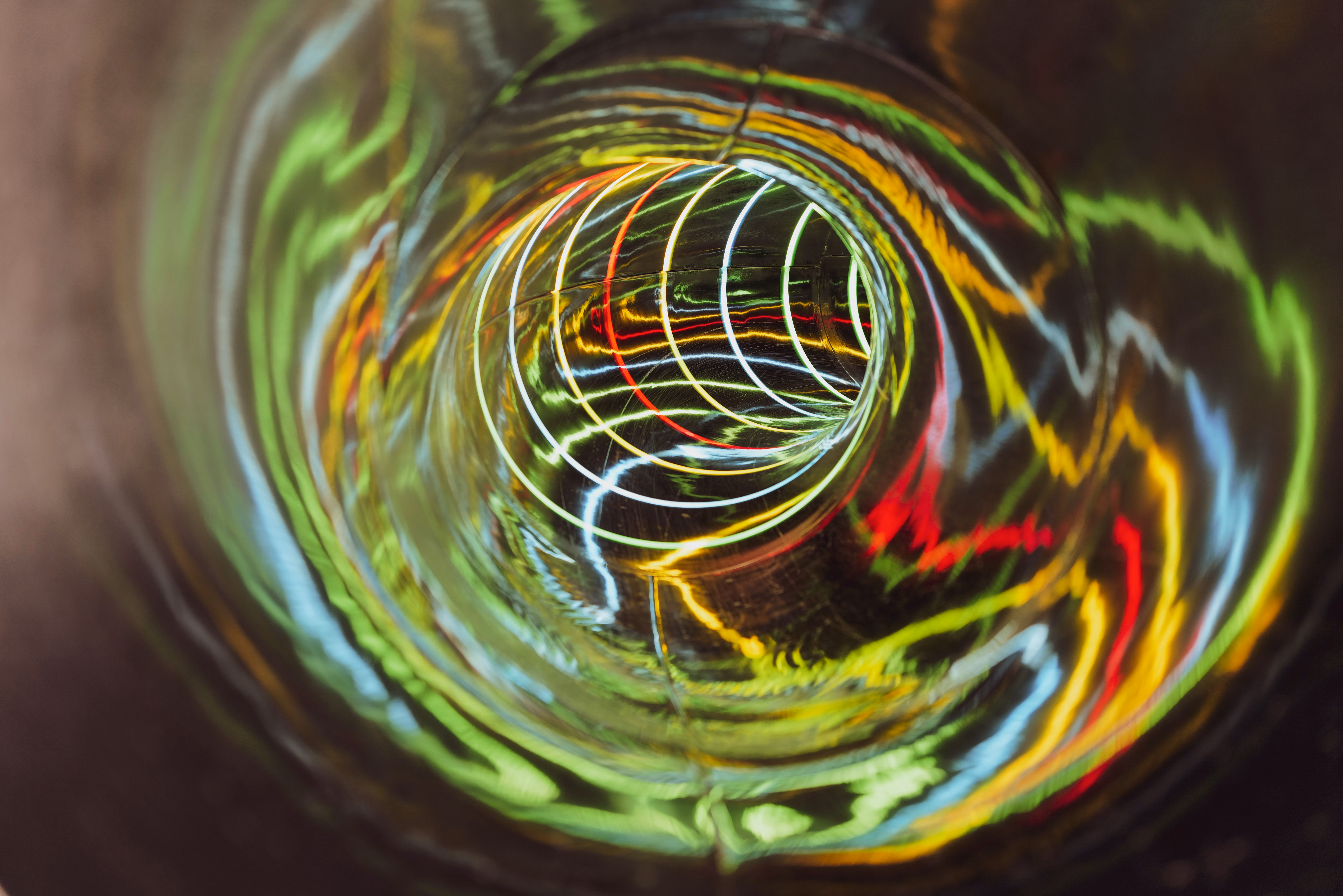 Coloured light trails spiralling through a tunnel