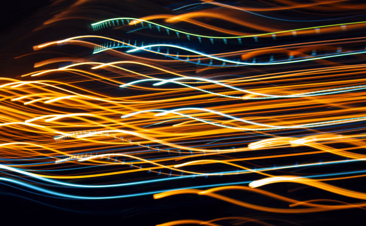 Streams of orange and blue light flowing in parallel