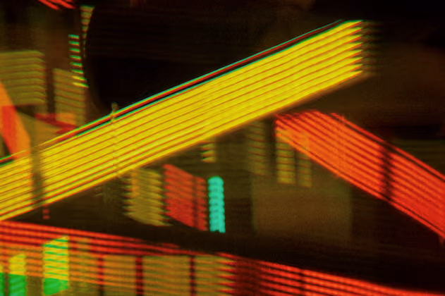 Bands of yellow and red light crossing in the dark